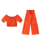 Set di due pezzi composto da top con spalle scoperte e maniche a sbuffo e pantaloni a gamba larga