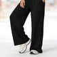 Completo da donna composto da top corto con scollo all'americana e pantaloni a gamba larga.